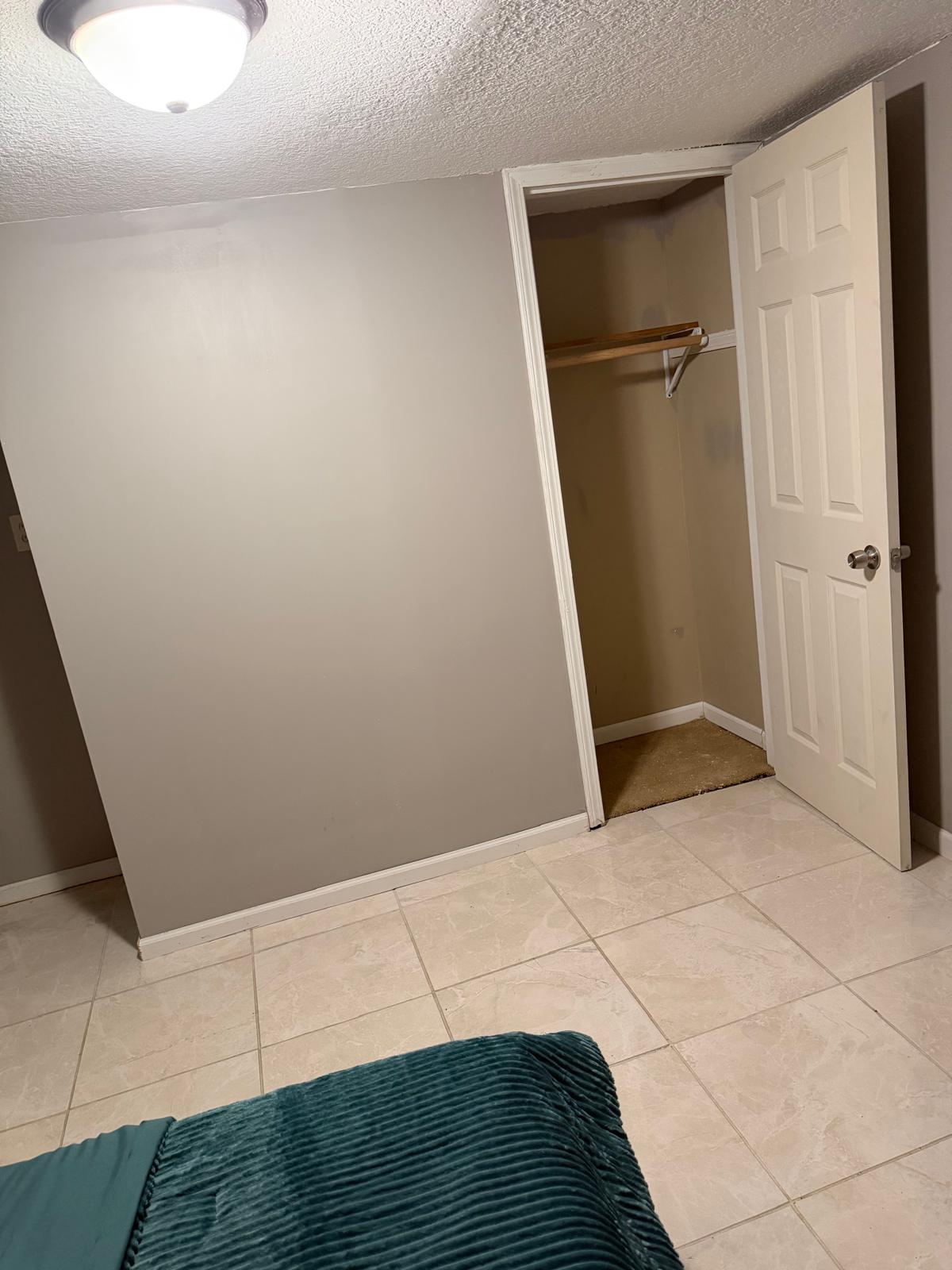 Private bedroom closet with built-in shelf and hanging space