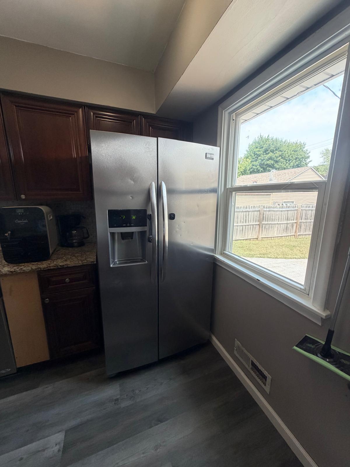 Kitchen counter, sink, cabinets, and appliances