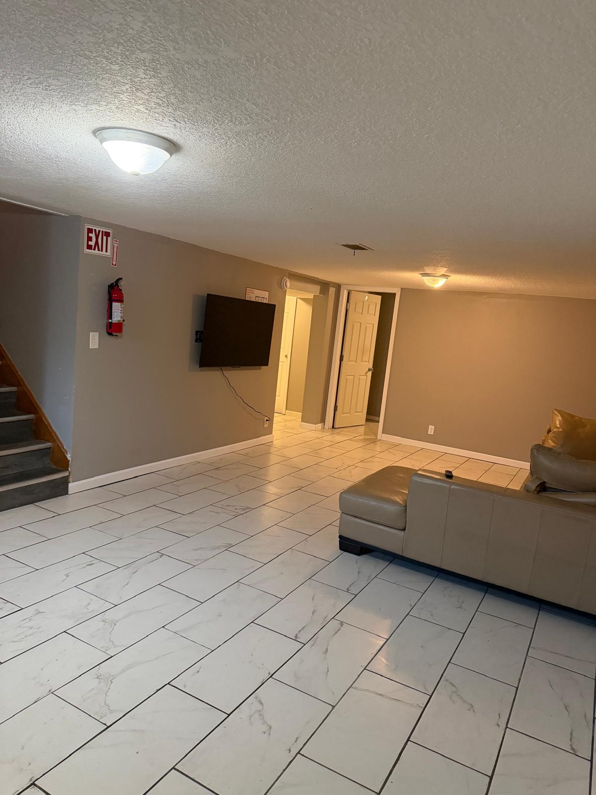 Wide view of the living area with television and seating