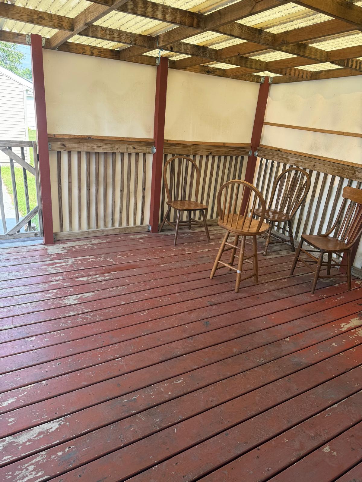 Covered outdoor porch with wooden seating